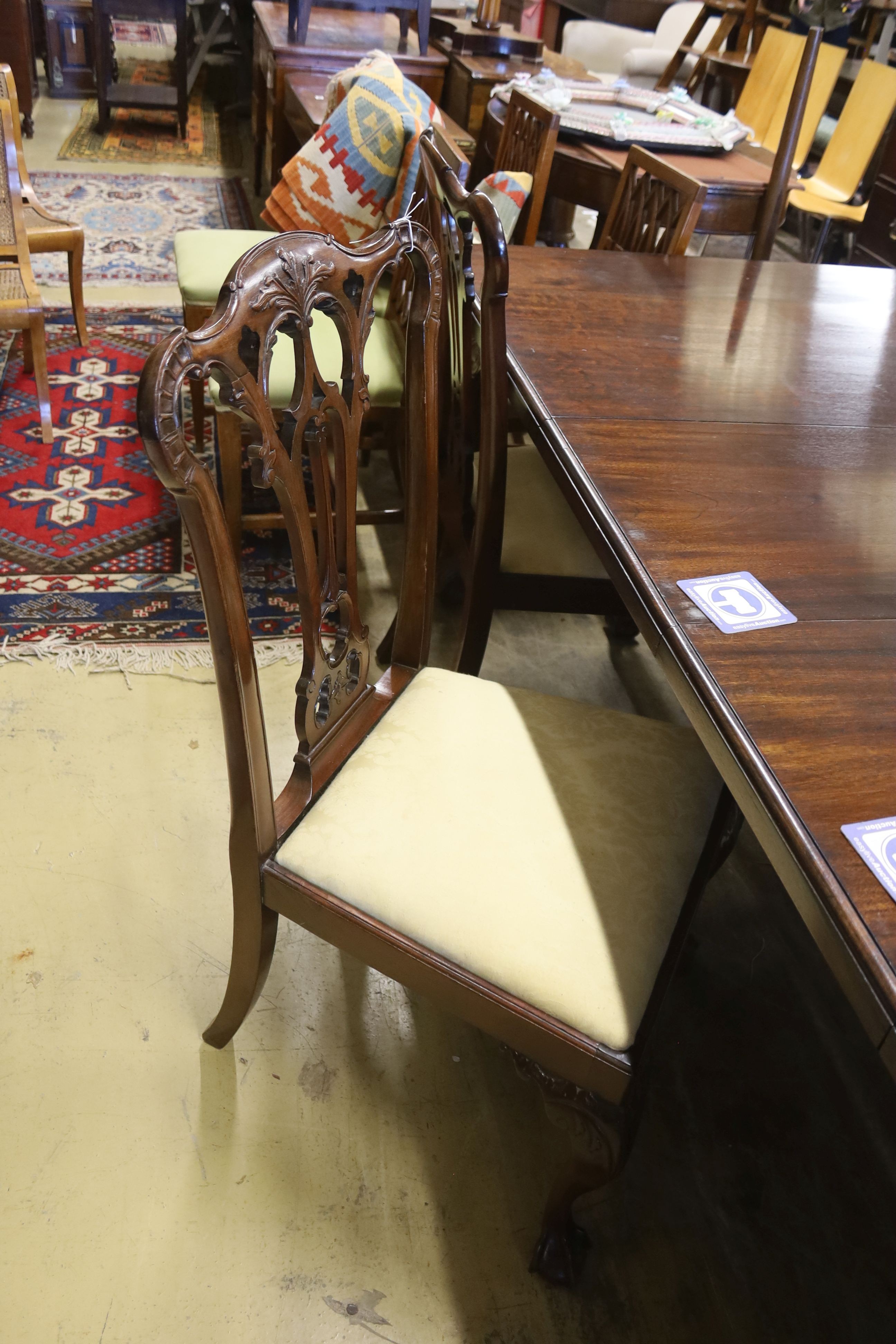 A set of eight George III style mahogany dining chairs with ball and claw feet together with a similar mahogany extending dining table, length 240cm extended (two spare leaves), width 106cm, height 74cm